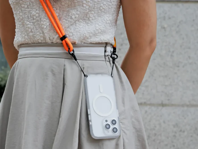 a person wearing a white dress with a phone attached to her waist