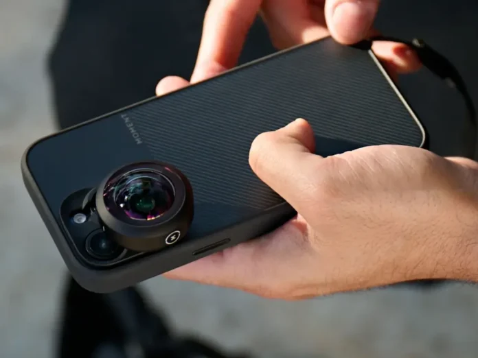 a person holding a cell phone with a camera lens