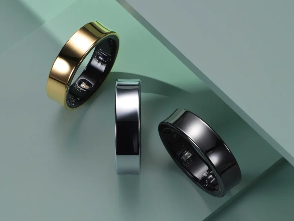 a group of rings on a green surface. Samsung Galaxy Ring.  {Tech} for Travel. https://techfortravel.co.uk