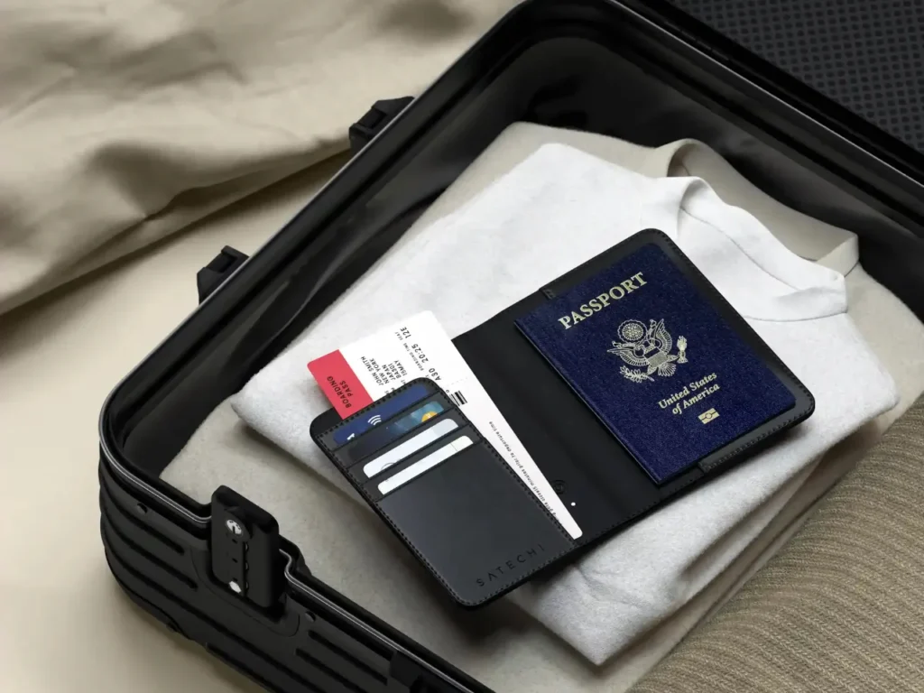 a passport and tickets in a suitcase. Satechi Passport Cover with Find My.  {Tech} for Travel. https://techfortravel.co.uk