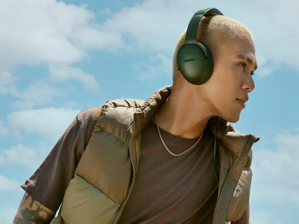 a man wearing headphones. Bose QuietComfort SC. Best Headphones for Travel 2025.  {Tech} for Travel. https://techfortravel.co.uk