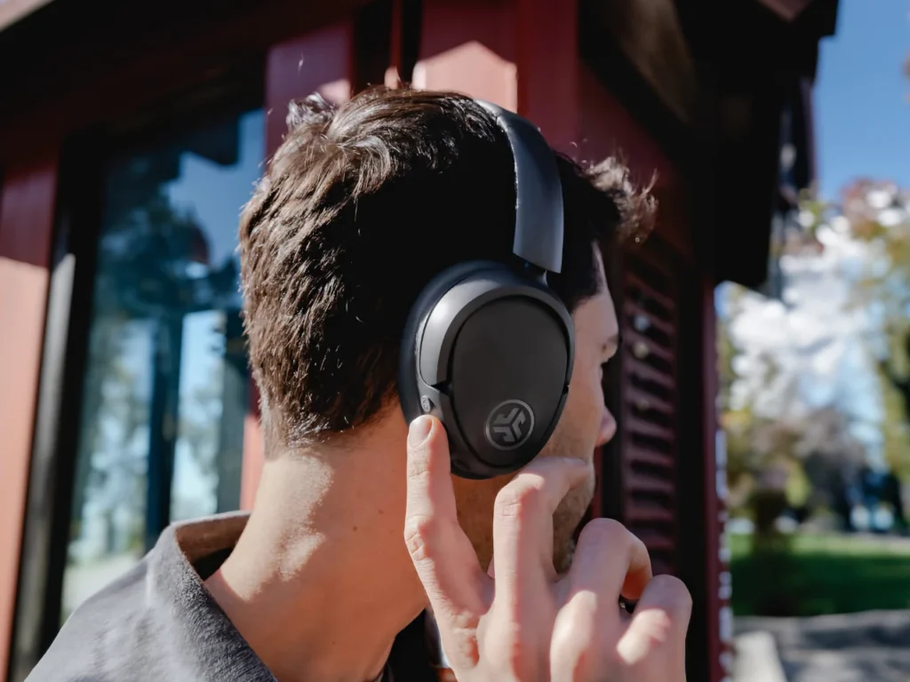 a man wearing headphones. Best Headphones for Travel 2025.  {Tech} for Travel. https://techfortravel.co.uk