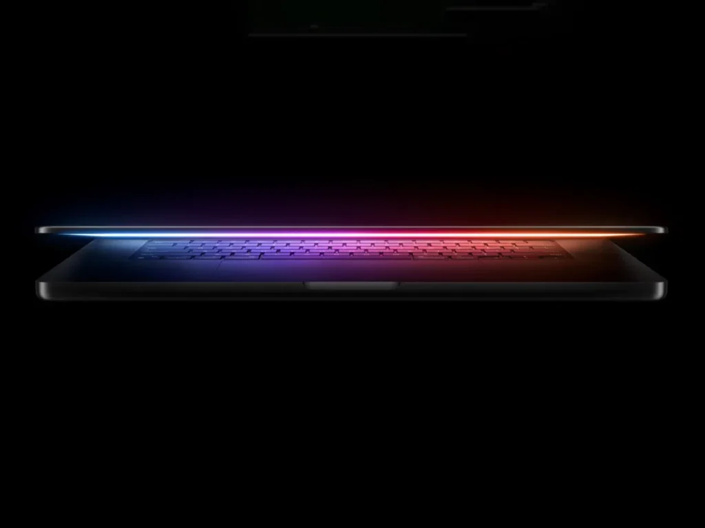 a laptop with a rainbow light. Apple MacBook Pro M4 Specifications.  {Tech} for Travel. https://techfortravel.co.uk