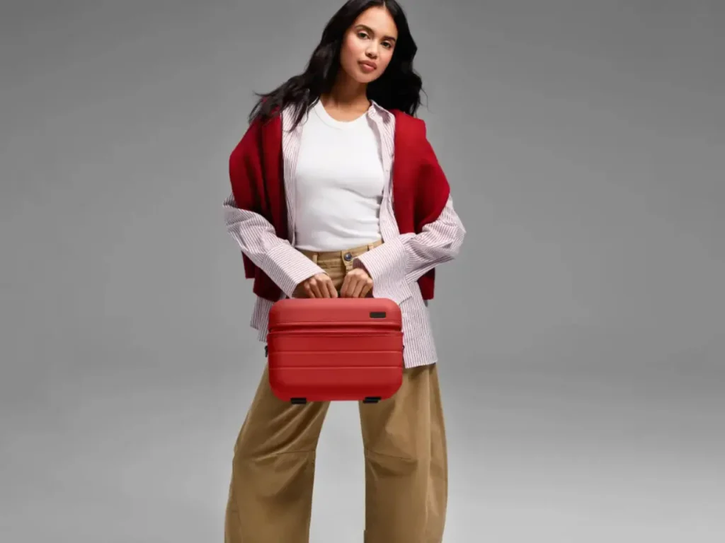 a woman holding a red suitcase. Away Train Case in Red. {Tech} for Travel. https://techfortravel.co.uk