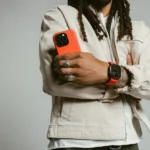 a man holding a cell phone. Nomad Goods Magma Collection Lifestyle 1