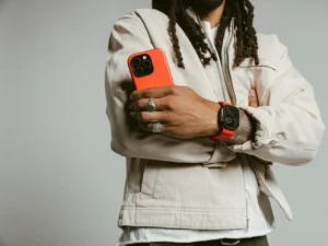 a man holding a cell phone. Nomad Goods Magma Collection Lifestyle 1