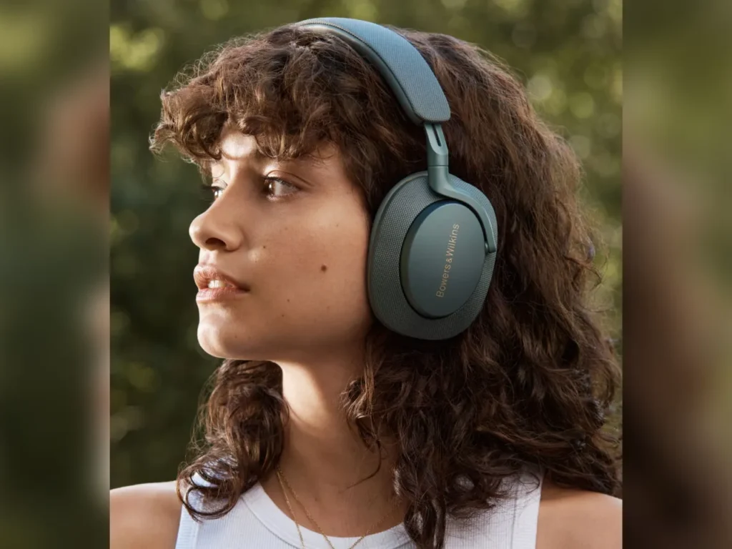 a woman wearing headphones. Best Headphones for Travel 2025.  {Tech} for Travel. https://techfortravel.co.uk