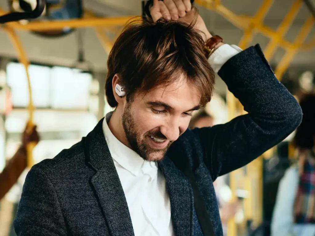 a man with a beard wearing a white shirt and black jacket. OpenRock X headphones. {Tech} for Travel. https://techfortravel.co.uk