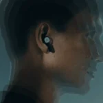 a man with a bluetooth earbud. Beoplay Eleven Earbuds. {Tech} for Travel. https://techfortravel.co.uk