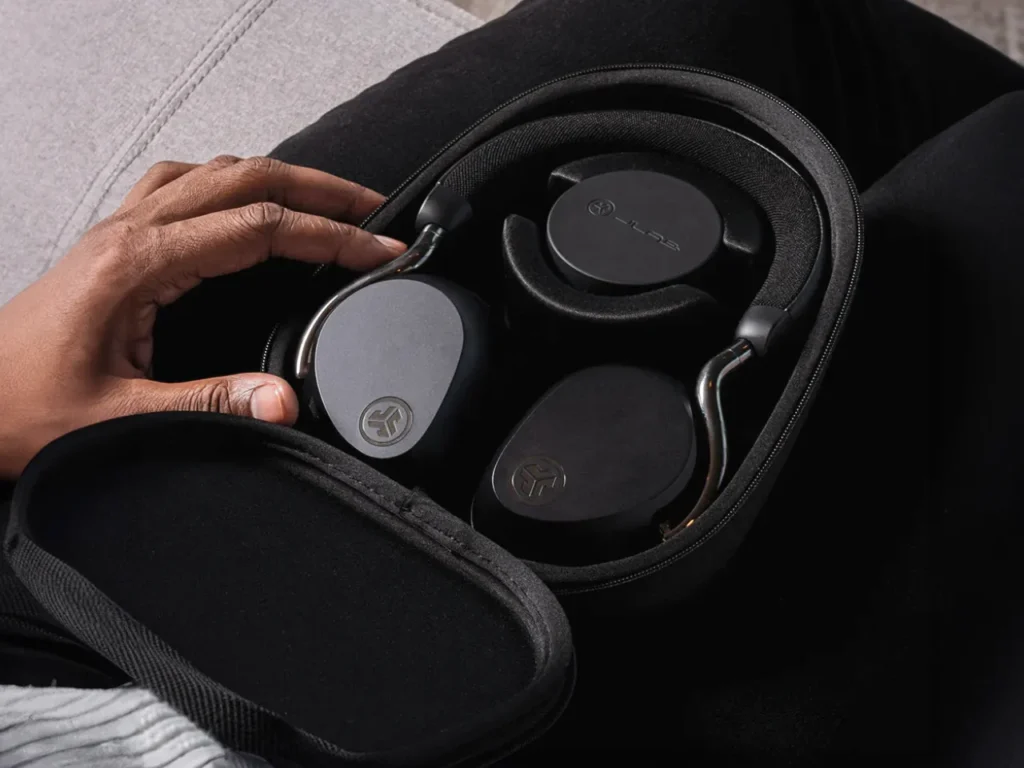 a person holding a black case with headphones in it. JLab Epic Lux Lab Edition Headphones. {Tech} for Travel. https://techfortravel.co.uk