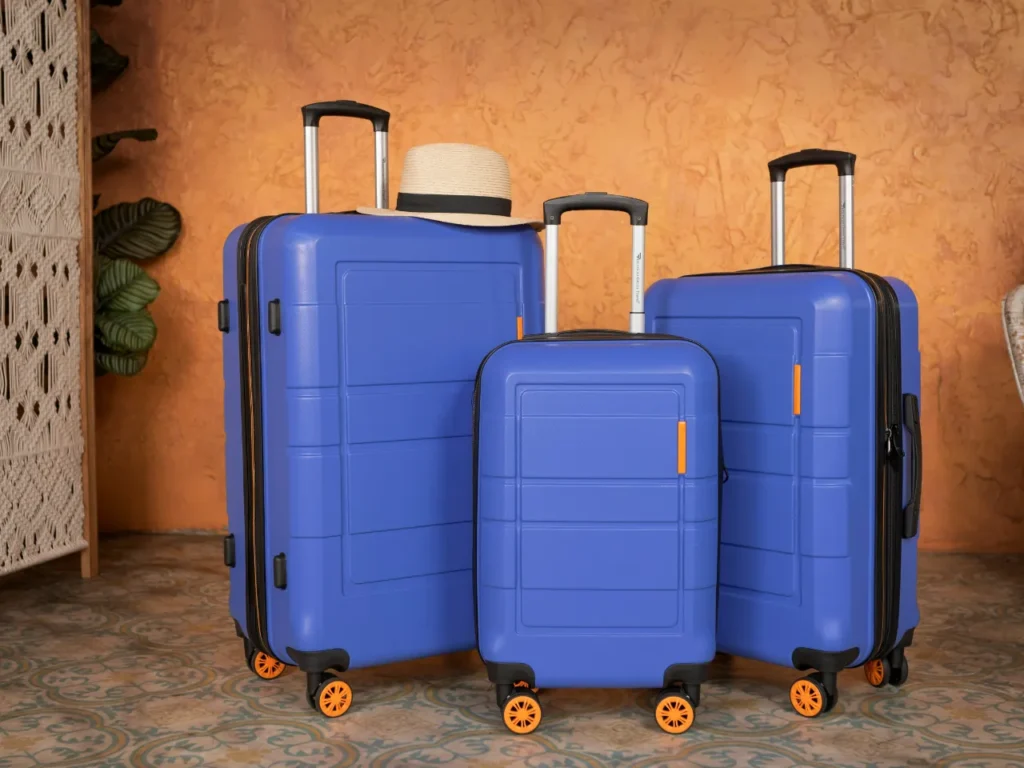 a group of blue suitcases with wheels and a hat on top.  Suitcases and Carry On.  {Tech} for Travel. https://techfortravel.co.uk