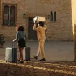 Away Suitcases and Why Frequent Travellers Love Them a man and woman carrying luggage. Away suitcases