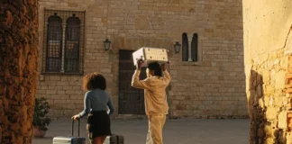 Away Suitcases and Why Frequent Travellers Love Them a man and woman carrying luggage. Away suitcases