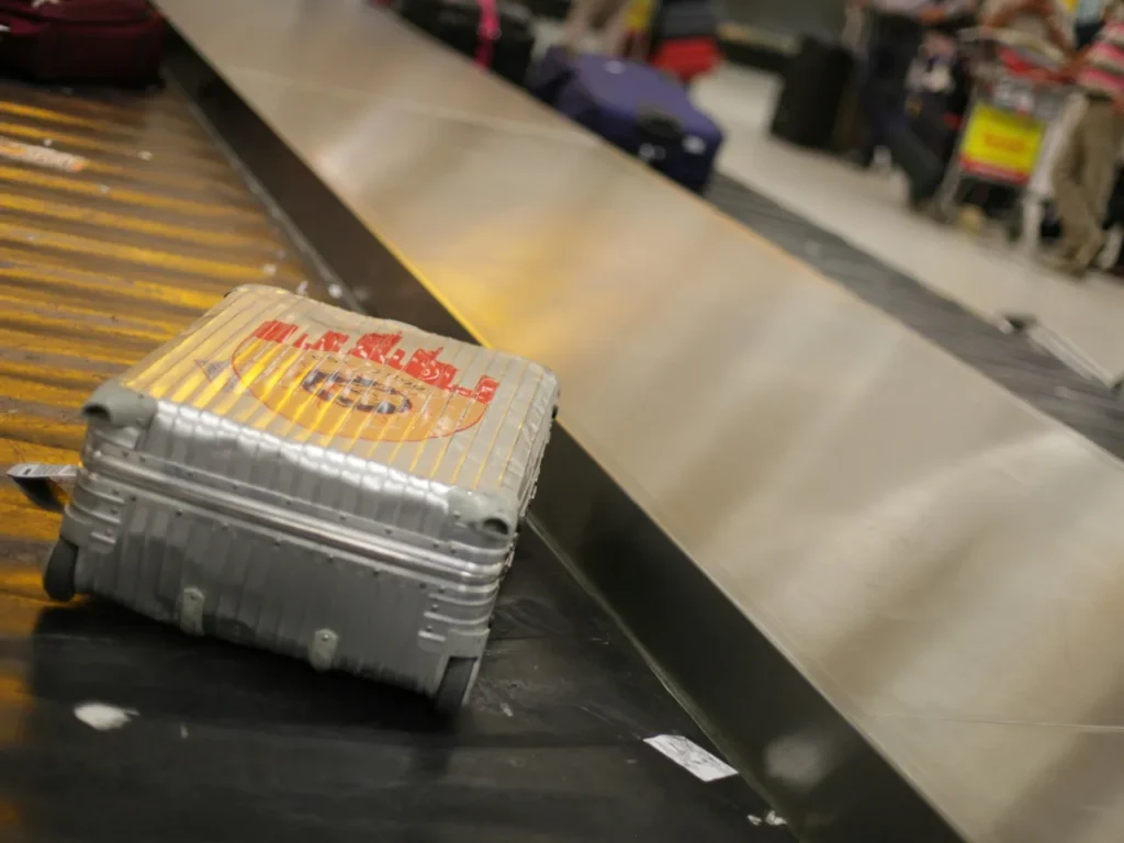 a suitcase on a conveyor belt.  Suitcases and Carry On.  {Tech} for Travel. https://techfortravel.co.uk