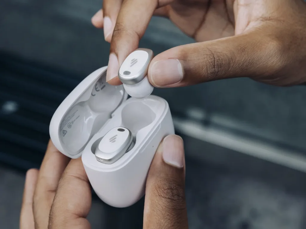 a person holding a white box with a silver earbuds in their case. Edifier NeoDots Review. {Tech} for Travel. https://techfortravel.co.uk