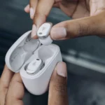 Edifier NeoDots Review: Stylish, Lightweight, and Powerful a person holding a white box with a silver earbuds in their case. Edifier NeoDots Review. {Tech} for Travel. https://techfortravel.co.uk