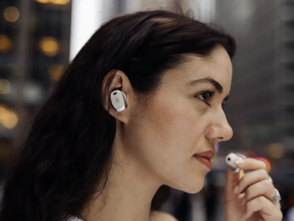 a woman with earbuds in her ear. Edifier NeoDots Review. {Tech} for Travel. https://techfortravel.co.uk