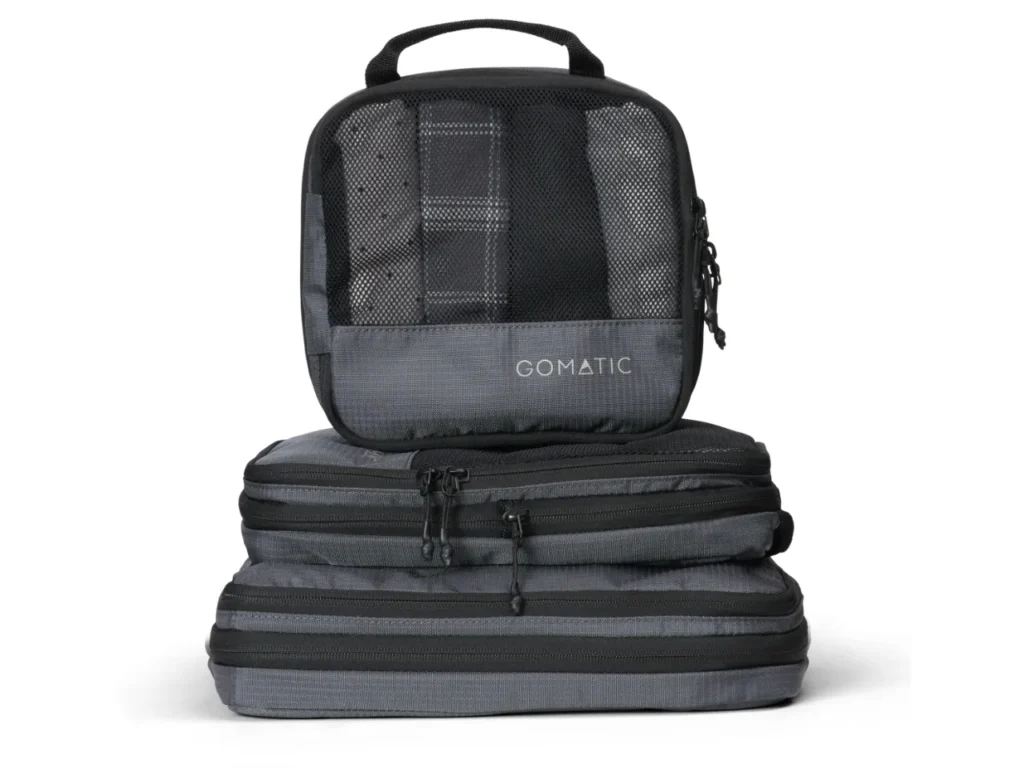 a stack of grey bags. Gomatic Packing Cubes. Nomatic Packing Cubes. Gomatic Accessories. {Tech} for Travel. https://techfortravel.co.uk