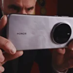 HONOR, Snapdragon & AI: The Future of Smartphone Photography a man holding a silver rectangular device