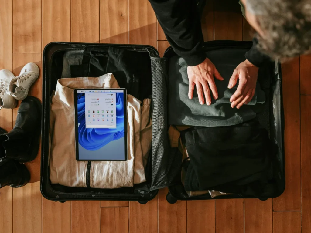 a person packing clothes in a suitcase. Suitcases and Carry On.  {Tech} for Travel. https://techfortravel.co.uk