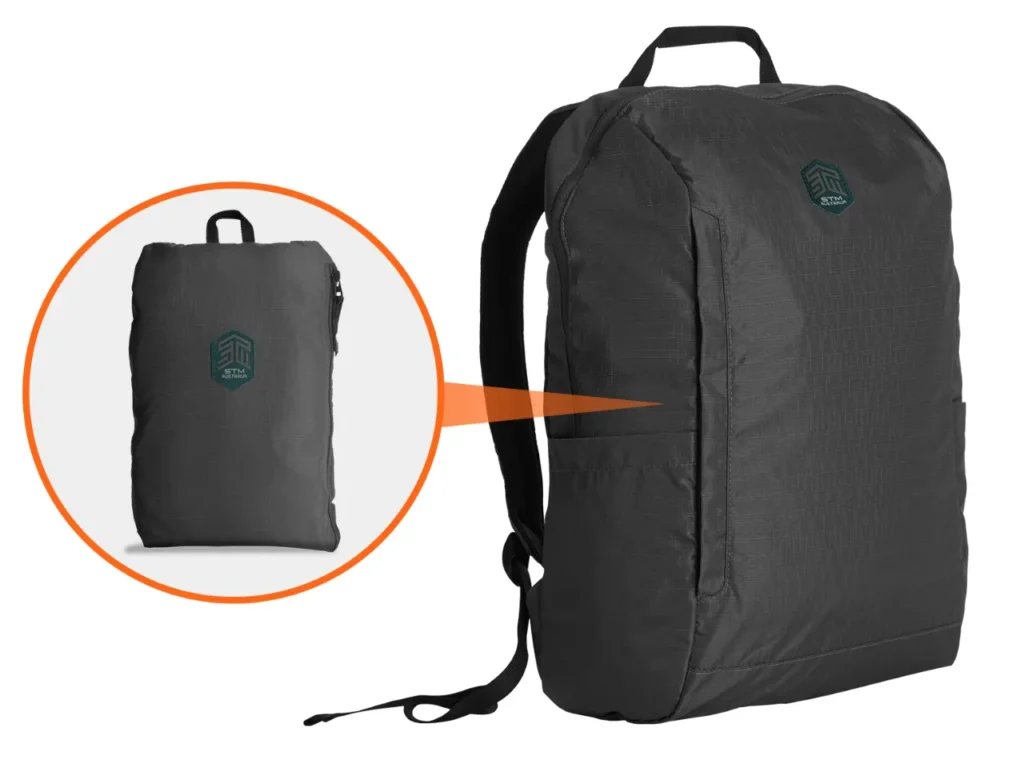 a black backpack with a logo on it. STM Goods BagPack review.  {Tech} for Travel. https://techfortravel.co.uk