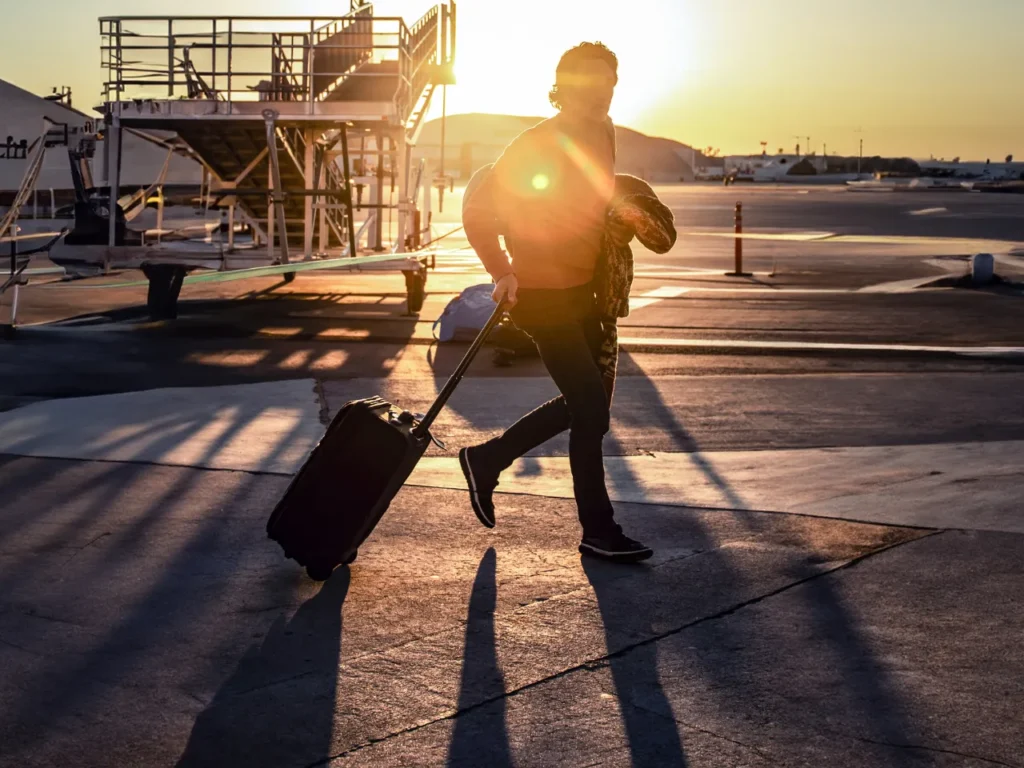 a man pulling a suitcase. Carry On suitcase.  {Tech} for Travel. https://techfortravel.co.uk