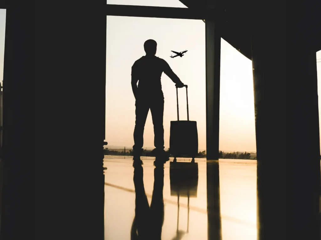 a silhouette of a man with a luggage bag. Carry On suitcase.  {Tech} for Travel. https://techfortravel.co.uk