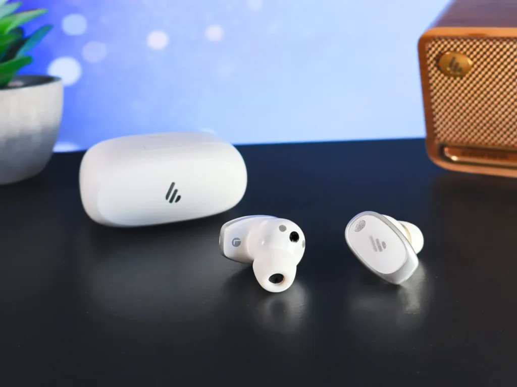 a group of white earbuds on a black surface. Edifier NeoDots Review.  {Tech} for Travel. https://techfortravel.co.uk