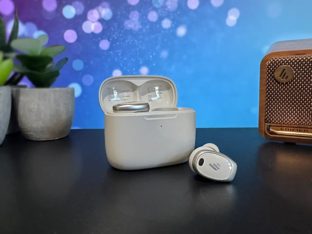 a white wireless earbuds on a black surface. Edifier NeoDots Review.  {Tech} for Travel. https://techfortravel.co.uk