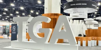 Accessories That Stood Out at Travel Goods Show 2025 a large white sign in a room. TGA Show 2025