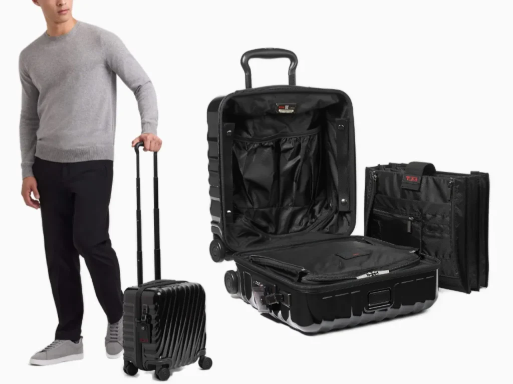 a man standing next to a suitcase. TUMI Small Compact Brief. Best Carry-On Cases 2025. {Tech} for Travel. https://techfortravel.co.uk