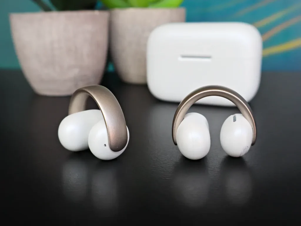 a pair of white headphones on a black surface. Soundcore Aeroclip review. {Tech} for Travel. https://techfortravel.co.uk