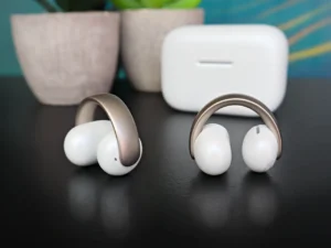 a pair of white headphones on a black surface
