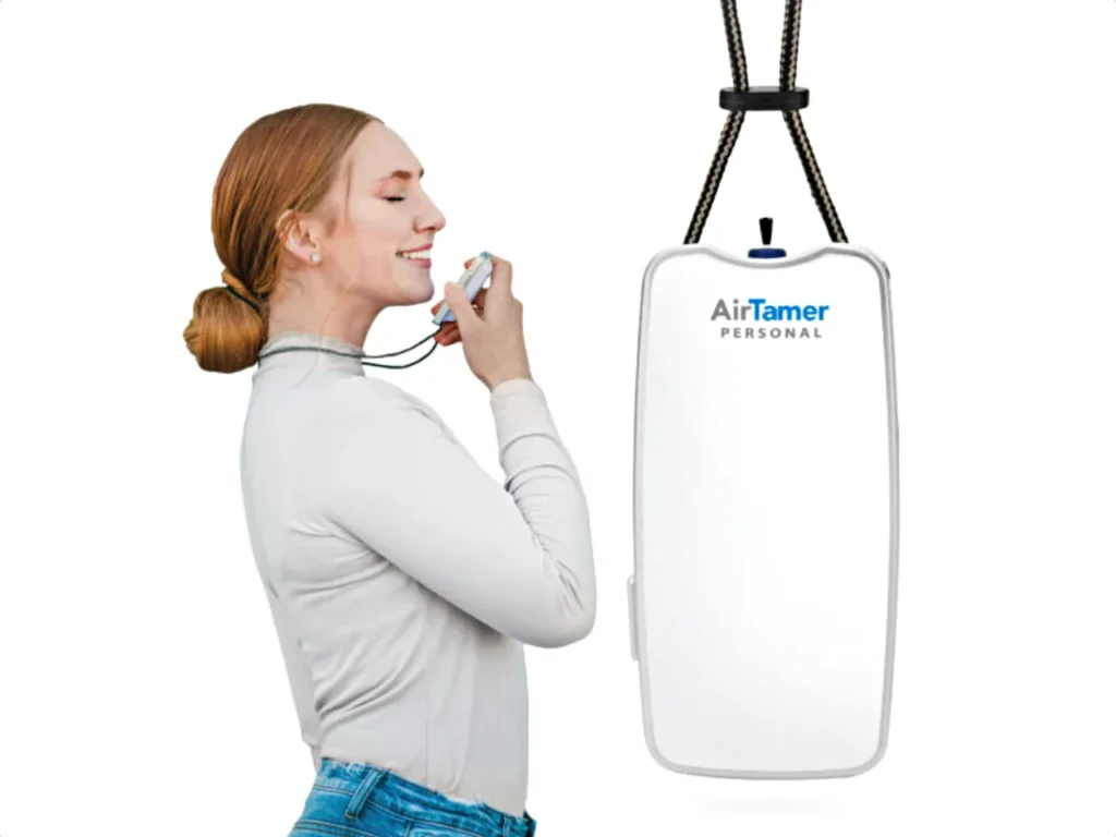 Air Tamer A310 – {Tech} for Travel a woman with a device in her hand. AirTamer A310. Healthy Travel Gadgets. {Tech} for Travel. https://techfortravel.co.uk