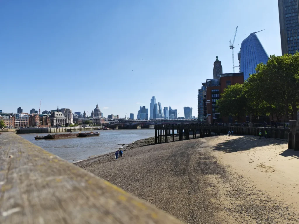 a beach with a city skyline in the background