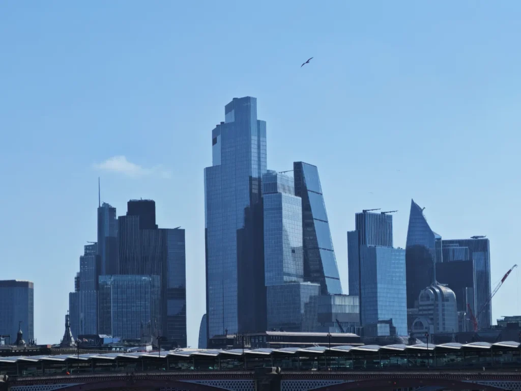 a city skyline with a bird flying over it