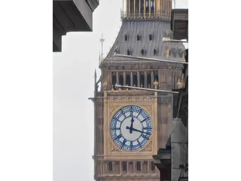 a clock tower with a blue and white face