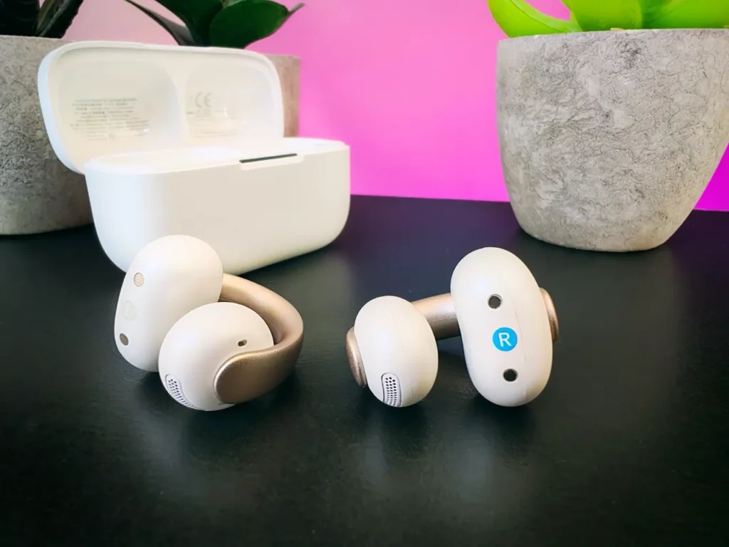 Soundcore AeroClip Earbuds Profile – {Tech} for Travel a pair of white earbuds on a black surface. Soundcore AeroClip earbuds. Father's Day Gift Ideas. {Tech} for Travel. https://techfortravel.co.uk