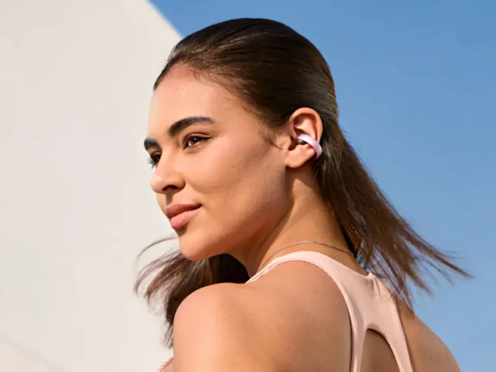 a woman with a pink earbud. Soundcore Aeroclip review. {Tech} for Travel. https://techfortravel.co.uk