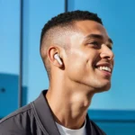 a man smiling with earbuds. Soundcore Liberty 5 Earbuds. {Tech} for Travel. https://techfortravel.co.uk