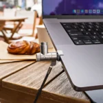 HyperShield MacBook Pro Cable Lock Secures Without Tools a laptop with a microphone attached to the back. HyperShield MacBook Pro Cable Lock. {Tech} for Travel. https://techfortravel.co.uk