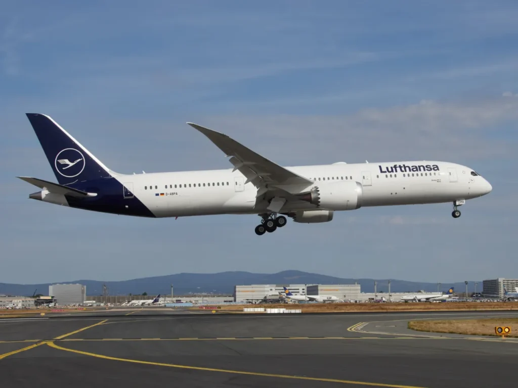 Lufthansa 787 Aircraft – {Tech} for Travel a white airplane flying over a runway. Lufthansa Wi-Fi Free Messaging. {Tech} for Travel. https://techfortravel.co.uk
