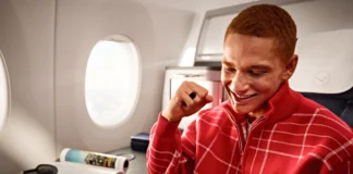 Lufthansa Wi-Fi Adds Free Chat on All Intercontinental Routes a man sitting on an airplane looking at a cellphone. Lufthansa Wi-Fi Free Messaging. {Tech} for Travel. https://techfortravel.co.uk