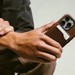 a person holding a cell phone. Nomad Leather Mag Wallet. {Tech} for Travel. https://techfortravel.co.uk