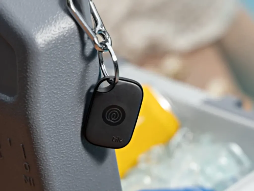 Tile Pro Black – {Tech} for Travel a key chain on a metal object. Best Luggage Tracker. Tile Pro. {Tech} for Travel. https://techfortravel.co.uk. Best Luggage Trackers