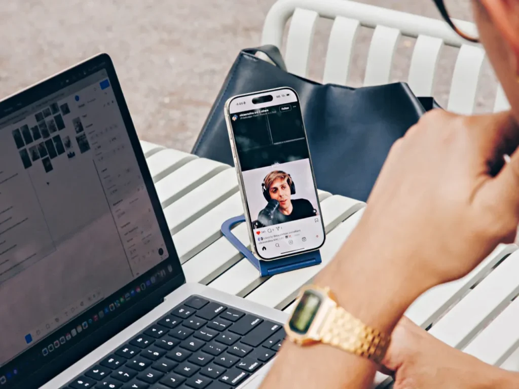 Twelve South Curve Nano Portrait – {Tech} for Travel a person sitting at a table with a laptop and a cell phone. Twelve South Curve Nano. {Tech} for Travel. https://techfortravel.co.uk