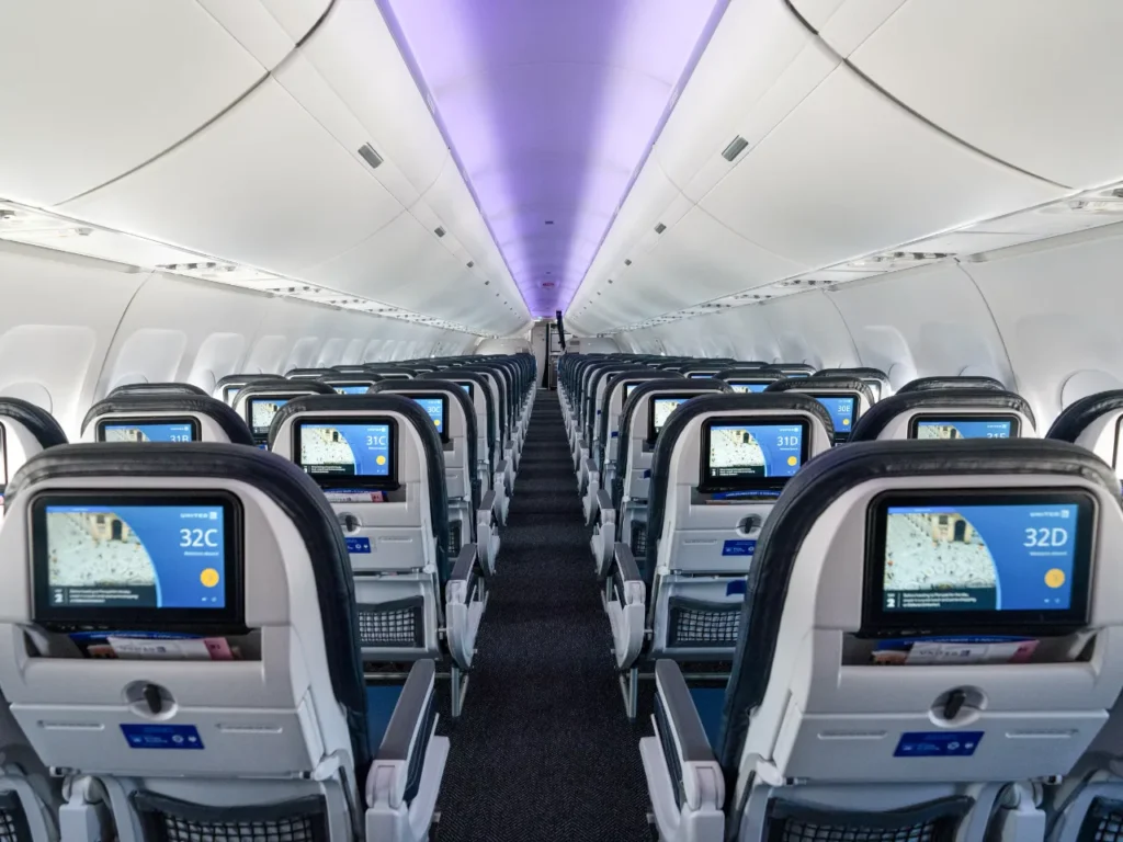 United Airlines Spotify Seat backs – {Tech} for Travel rows of seats in an airplane. United Airlines Spotify. {Tech} for Travel. https://techfortravel.co.uk