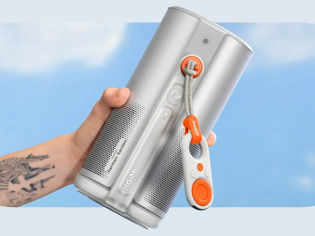 XGIMI MoGo 4 Projector Hero – {Tech} for Travel a hand holding a speaker. XGIMI MoGO 4 series Projector. {Tech} for Travel. https://techfortravel.co.uk