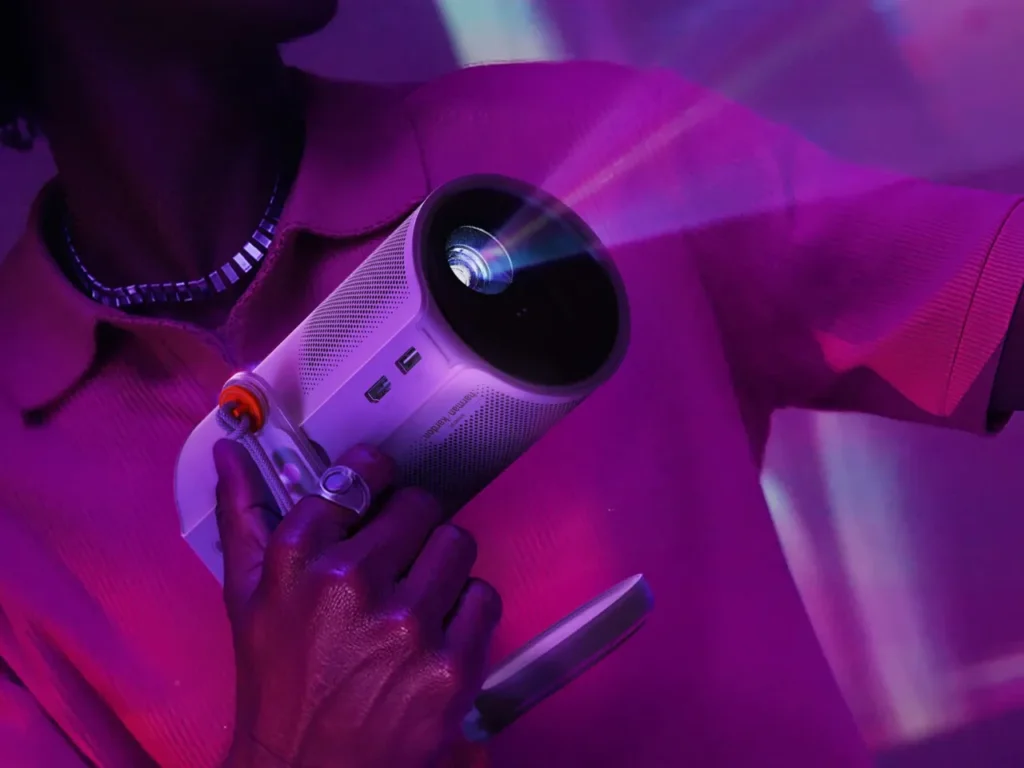 XGIMI MoGo 4 Projector in hand – {Tech} for Travel a person holding a projector. XGIMI MoGO 4 series Projector. {Tech} for Travel. https://techfortravel.co.uk