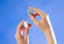 hands holding a hearing aid. Natura AI HumanPods. {Tech} for Travel. https://techfortravel.co.uk